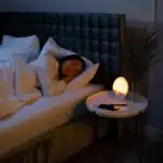 A woman sleeping peacefully in bed at night with soft lighting