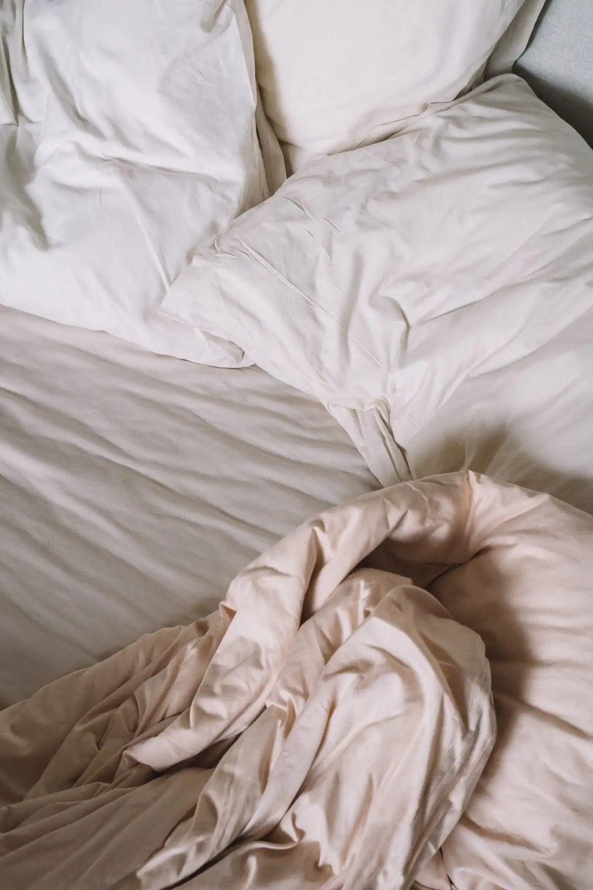 Pillows and a folded blanket arranged on a bed